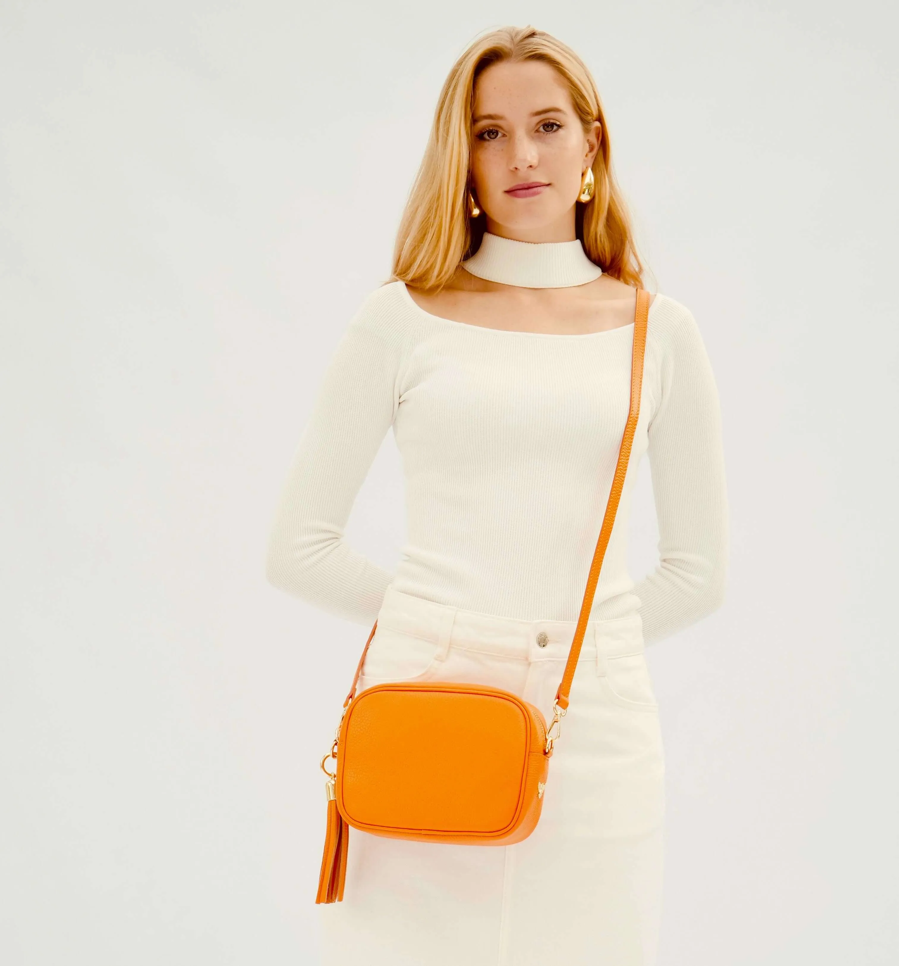 The Tassel Orange Leather Crossbody Bag With Orange Cross-Stitch Strap