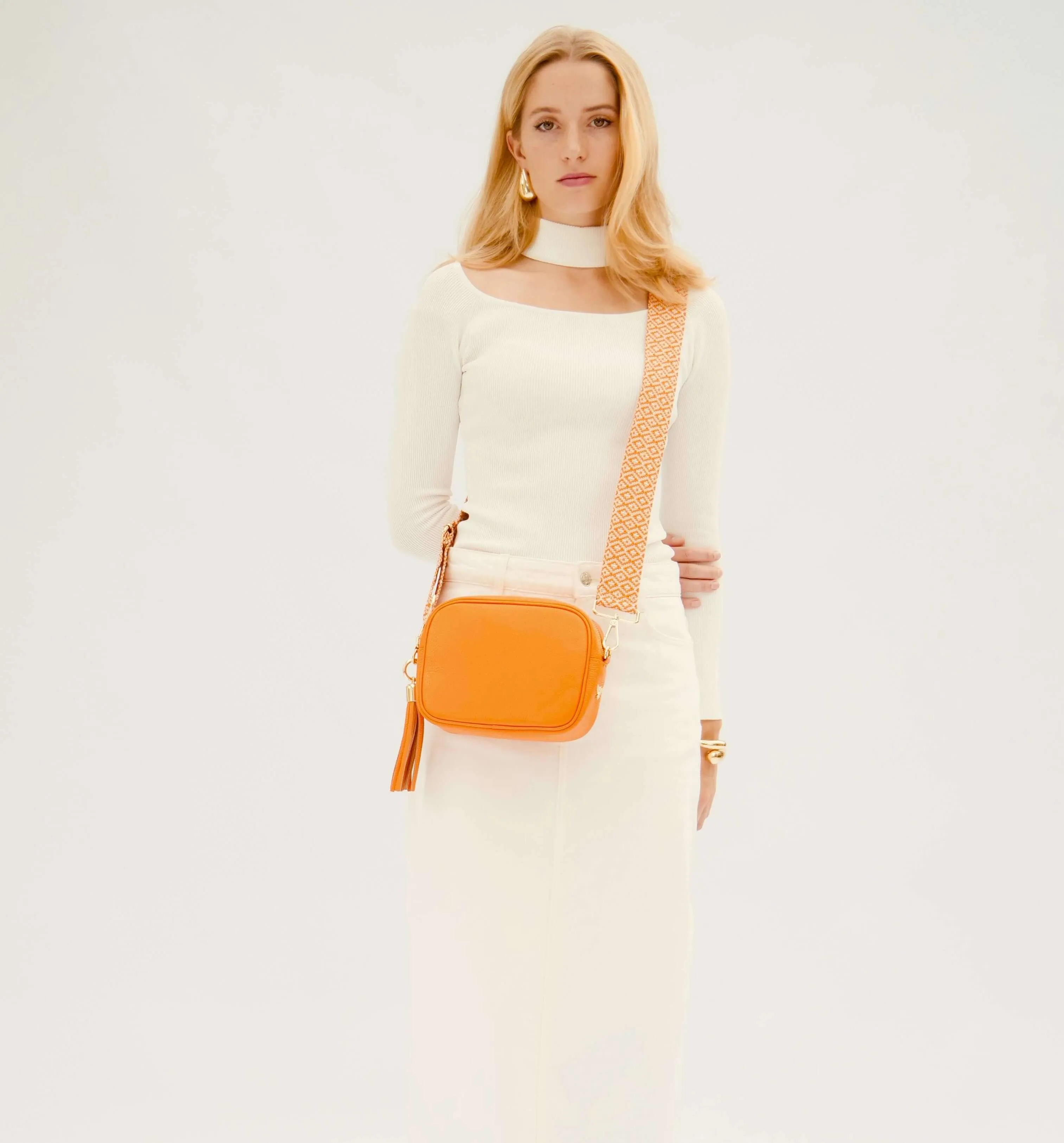 The Tassel Orange Leather Crossbody Bag With Orange Cross-Stitch Strap